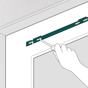 2. Drill pilot holes and screw the top bracket into the door.