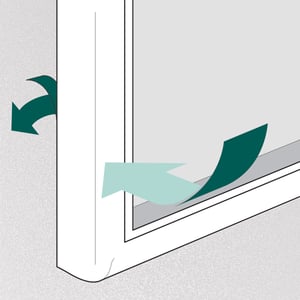 4. Secure lower corners to the door using the unit's peel-off adhesive pads.